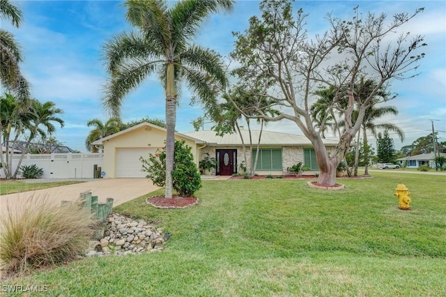 single story home featuring a front lawn and a garage