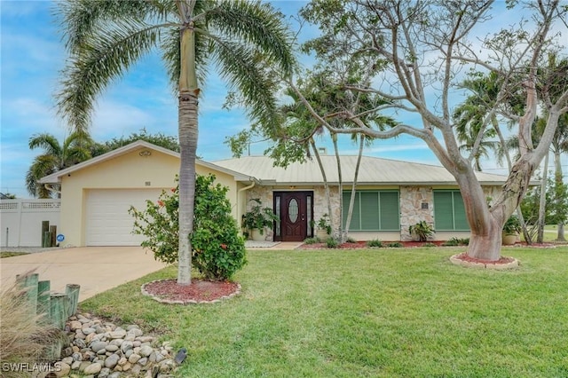 single story home featuring a front lawn and a garage