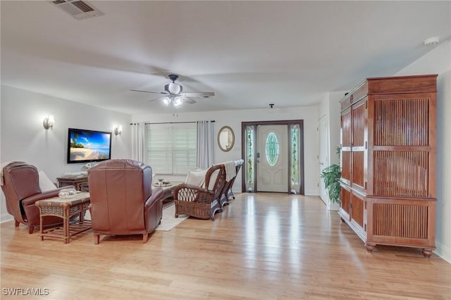 living room featuring ceiling fan and light wood-type flooring