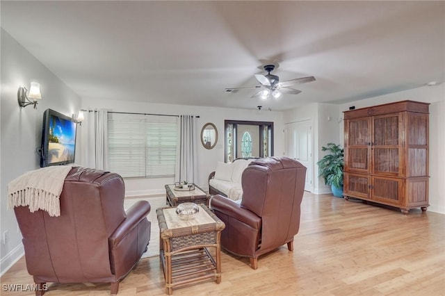 living room featuring ceiling fan and light hardwood / wood-style flooring