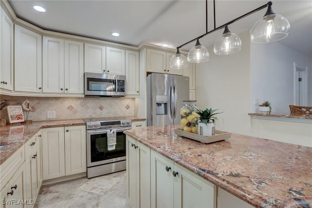 kitchen featuring stainless steel appliances, decorative backsplash, hanging light fixtures, light stone counters, and cream cabinetry