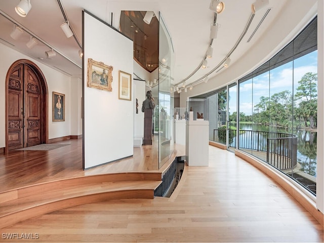 hallway featuring a water view and light hardwood / wood-style floors