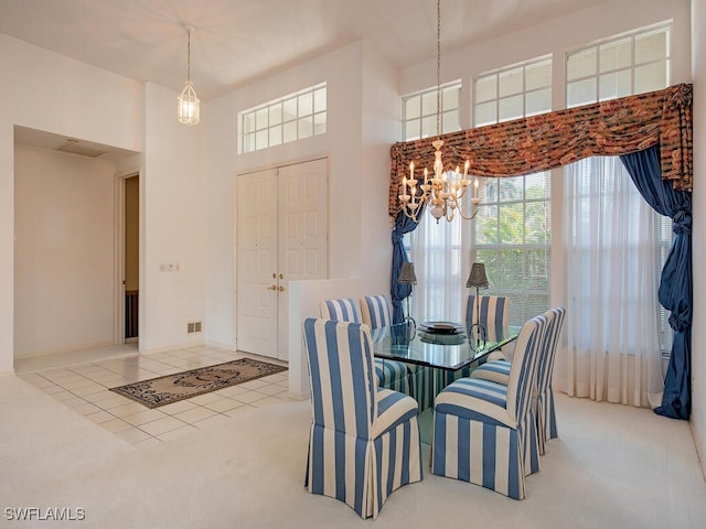 tiled dining room with a chandelier