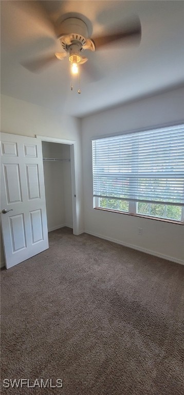 unfurnished bedroom featuring ceiling fan, a closet, and carpet floors