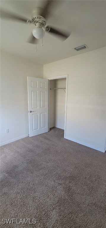 unfurnished bedroom with carpet flooring, a closet, and ceiling fan