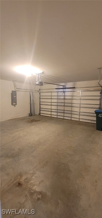 garage featuring electric panel and a garage door opener