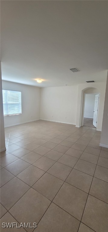 spare room featuring light tile patterned floors