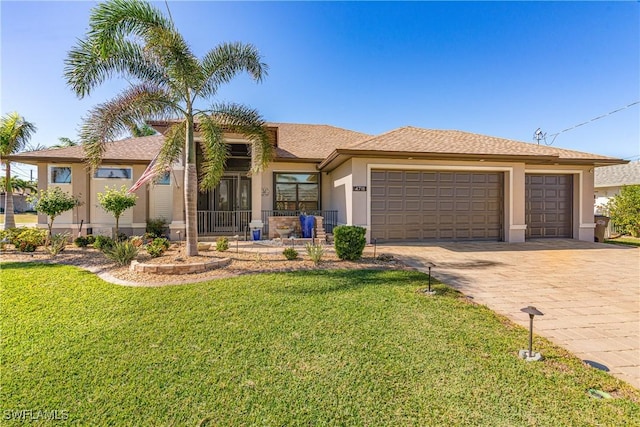 view of front of house featuring a front yard and a garage