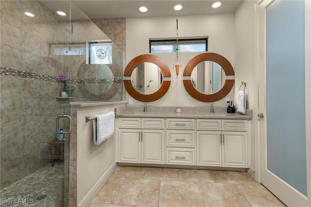 bathroom featuring an enclosed shower and vanity