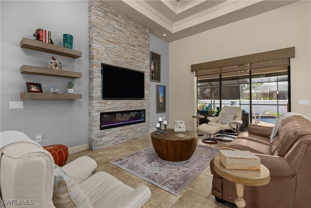 tiled living room with a high ceiling, a fireplace, a raised ceiling, and crown molding