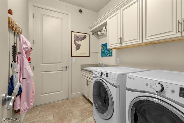 washroom with separate washer and dryer, cabinets, sink, and light tile patterned floors