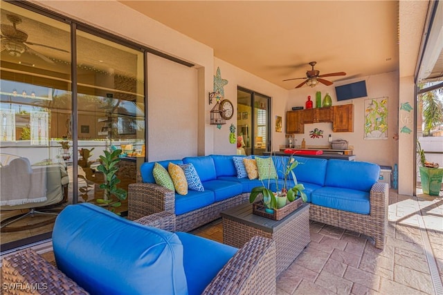 view of patio with ceiling fan and an outdoor hangout area