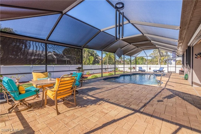 view of swimming pool with a patio area and glass enclosure