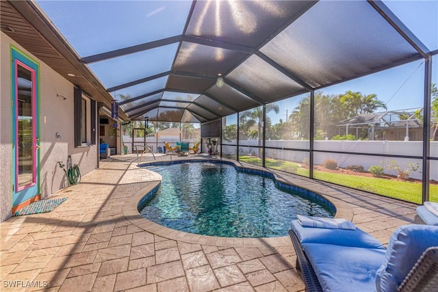 view of swimming pool with a lanai and a patio area