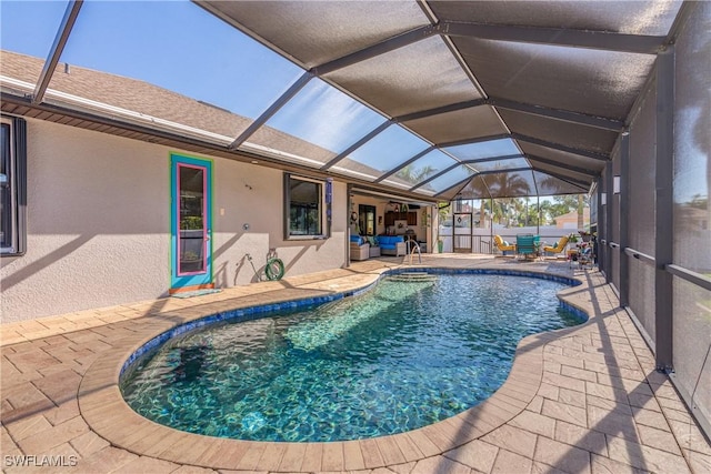 view of pool featuring a patio area and glass enclosure