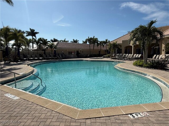 community pool with a patio area