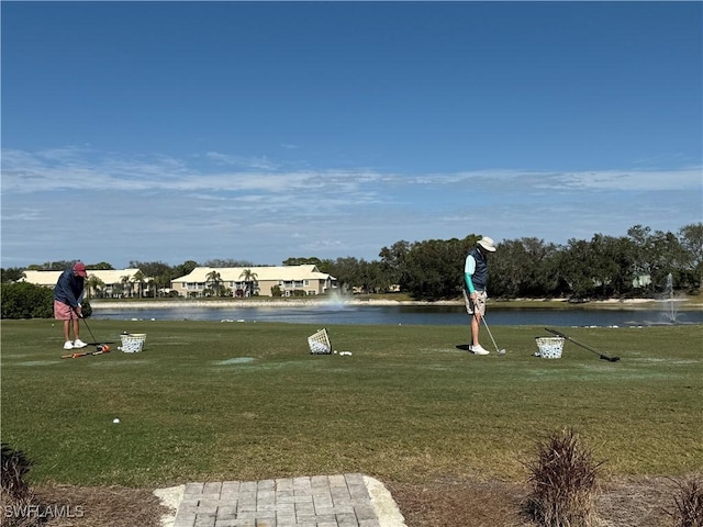 surrounding community featuring a lawn and a water view