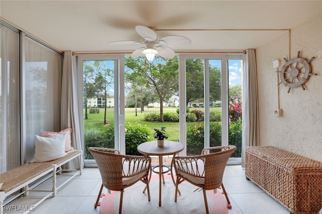 sunroom / solarium featuring ceiling fan