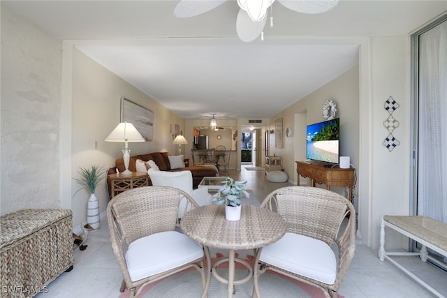 living room with ceiling fan and light tile patterned flooring