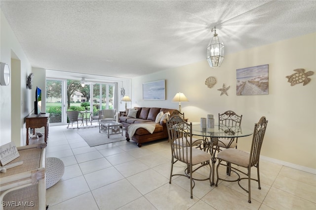 tiled dining room featuring a textured ceiling