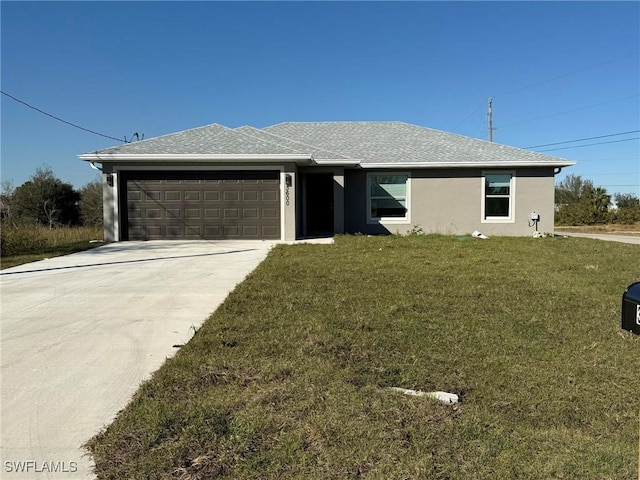 ranch-style home with a garage and a front yard