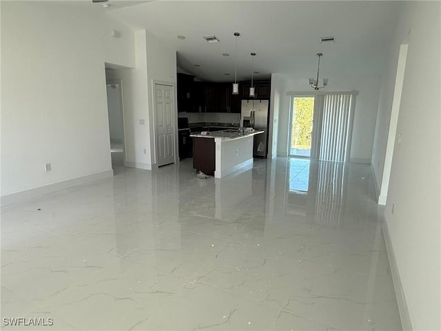 kitchen with a kitchen island, decorative light fixtures, and stainless steel refrigerator with ice dispenser