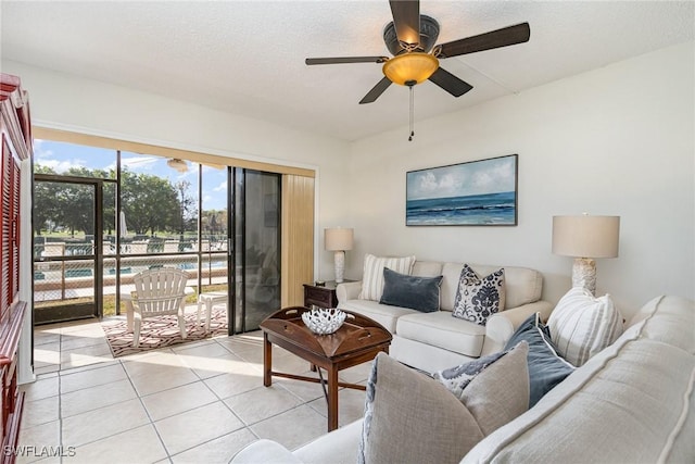 tiled living room featuring ceiling fan and a textured ceiling