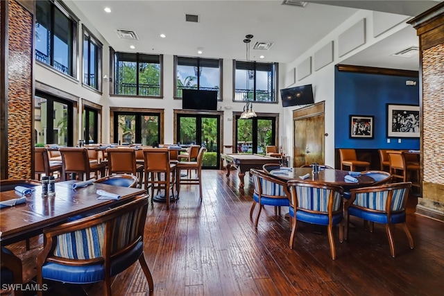 dining room featuring a high ceiling, hardwood / wood-style floors, billiards, and french doors