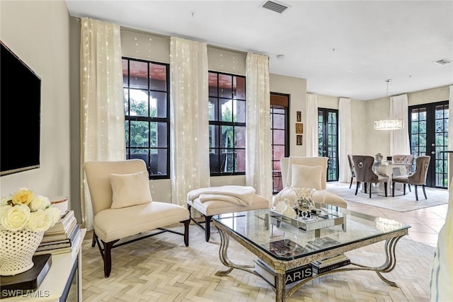 living area with light parquet flooring and french doors