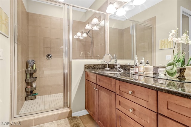 bathroom with tile patterned flooring, an enclosed shower, and vanity