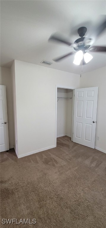 unfurnished bedroom with carpet flooring, ceiling fan, and a closet