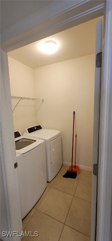 laundry area with tile patterned flooring and washing machine and clothes dryer