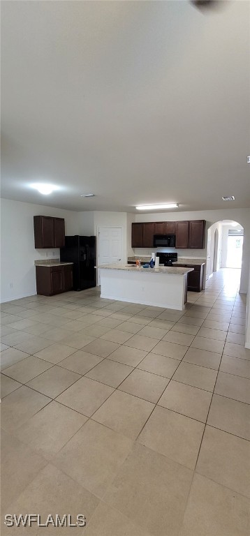 unfurnished living room featuring light tile patterned floors