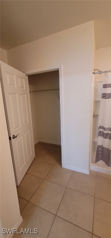 interior space with light tile patterned floors and a closet