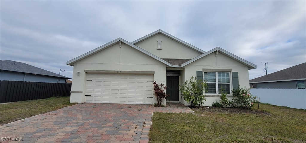 ranch-style home with a garage and a front yard