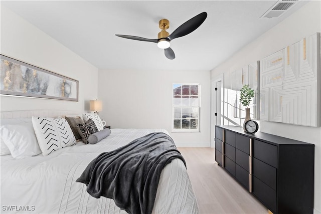 bedroom with light hardwood / wood-style flooring and ceiling fan