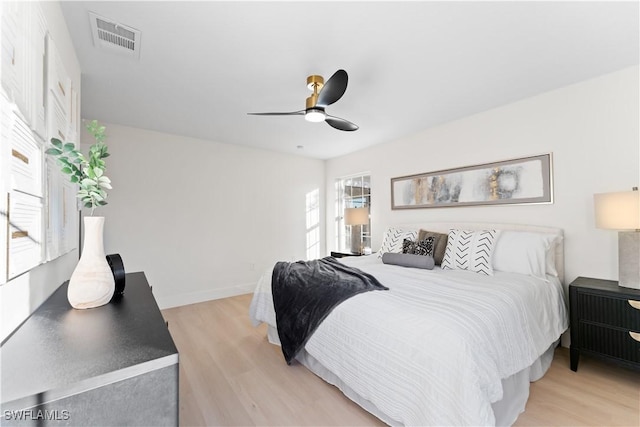 bedroom with ceiling fan and light hardwood / wood-style flooring