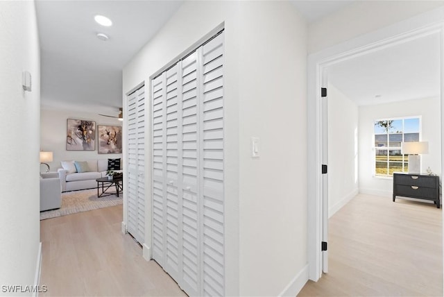 corridor with light hardwood / wood-style floors