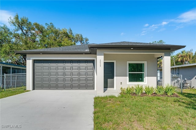 view of front of home featuring a garage and a front yard