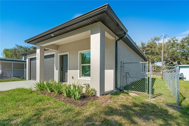 view of property exterior featuring a yard and a garage