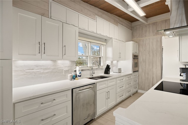 kitchen featuring appliances with stainless steel finishes, island range hood, sink, white cabinets, and wooden ceiling