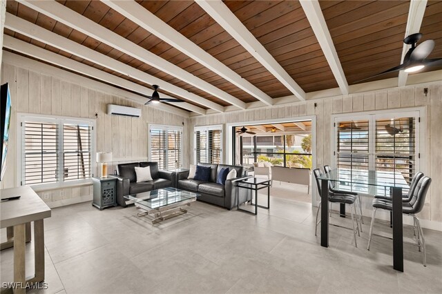 living room with lofted ceiling with beams, an AC wall unit, ceiling fan, a wealth of natural light, and wood ceiling