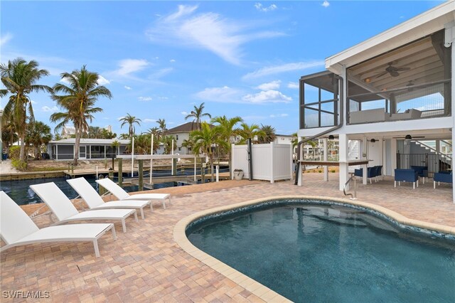 view of pool with ceiling fan and a patio area