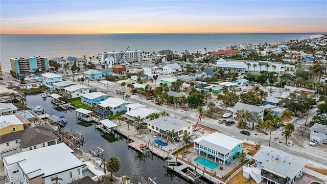 aerial view at dusk with a water view