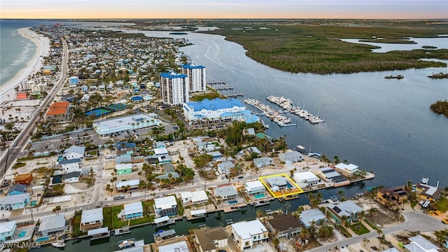 aerial view at dusk featuring a water view