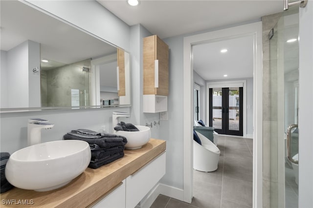 bathroom featuring french doors, tile patterned floors, vanity, and a shower with door