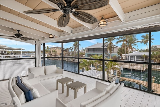 interior space featuring beamed ceiling, a water view, and ceiling fan