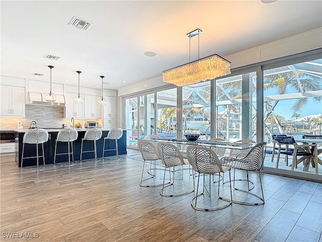 dining room with light hardwood / wood-style flooring and sink