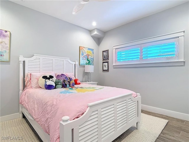 bedroom featuring hardwood / wood-style flooring and ceiling fan