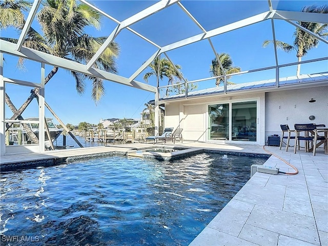 view of swimming pool with glass enclosure, an in ground hot tub, and a patio